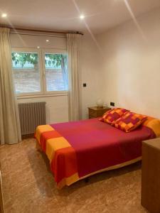 a bedroom with a large bed with a colorful blanket at GRANDIOSO CHALET EN CASTELL DE POBLA MONTORNES in Pobla de Montornés