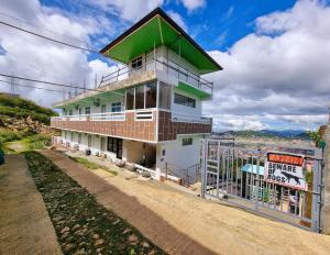 a building with a sign in front of it at Wanay's Rocky Mountain Homestay in Baguio