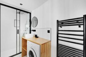 a bathroom with a washing machine and a mirror at Studio 2P renovated rue des Archives Marais Clim 4 in Paris
