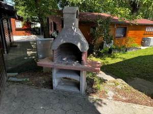 an outdoor oven in a yard in front of a house at OASIS Aqualuna & Terme Olimia G110 in Podčetrtek