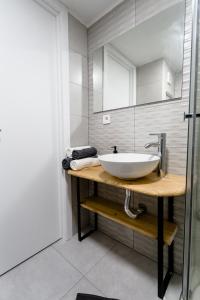 y baño con lavabo blanco y espejo. en Modern studio with see and city view en Benidorm