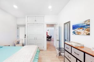 a bedroom with a bed and a desk at Driftwood Duet in Bandon