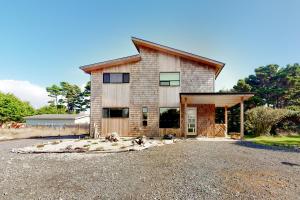 a large house with a gambrel roof at Driftwood Duet in Bandon