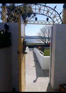 an open door to a patio with a view of the water at Dingle Wheelhouse in Dingle