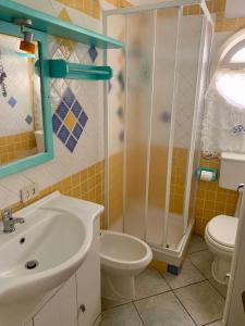a bathroom with a sink and a toilet and a shower at Casa Terrazza Girasole in Costa Paradiso