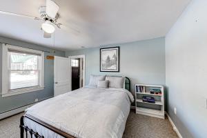 a bedroom with a bed and a ceiling fan at Vermont Farm House and Studio in Proctorsville