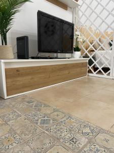a living room with a tv on a entertainment center at Solar das Flores - Moura in Moura