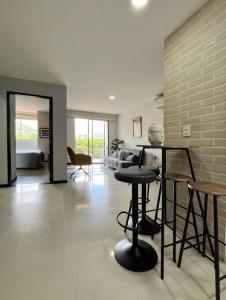 a living room with a table and some chairs at Comodo Departamento en el sur de Cali in Cali