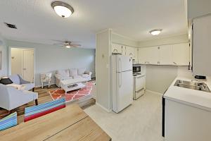 a kitchen and living room with a white refrigerator at Rockport Beach Club East & West in Rockport