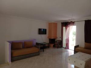 ein Wohnzimmer mit 2 Sofas und einem Tisch in der Unterkunft Chez Mostafa in Douar Ourlali