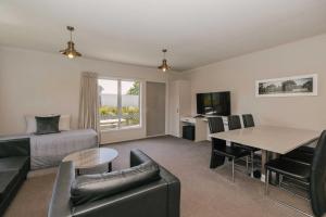 a living room with a couch and a table at South Street West Motel in Feilding