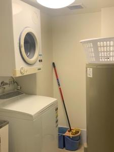 a kitchen with a refrigerator and a baseball bat at Northpoint Apartments in Port Macquarie