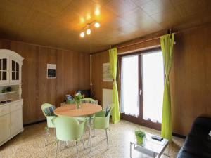 a dining room with a table and chairs and a window at Pleasant Holiday Home in Froidchapelle with Garden in Cerfontaine