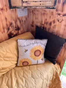 a bedroom with a bed with a pillow on it at Ty Gwenyn, Coity Bach in Brecon