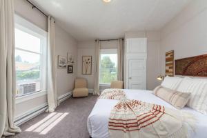 a bedroom with a large bed and a large window at Renovated 2 bed 2 bath Near Arena and Downtown in Spokane