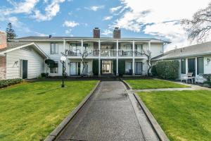 a white house with a porch and a lawn at Silverado Resort and Spa 271 & 272 in Napa