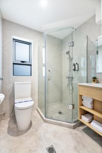 a bathroom with a shower and a toilet and a sink at Best Western Newmarket Inn & Suites in Auckland