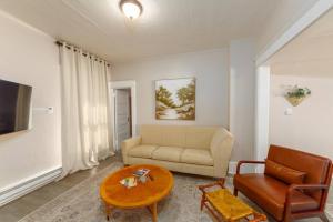 a living room with a couch and a table at Historic 2 KING BED 1 Bath Near Downtown Spokane in Spokane
