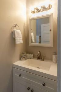 a bathroom with a sink and a mirror at Historic 2 KING BED 1 Bath Near Downtown Spokane in Spokane