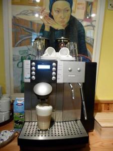 a coffee maker with a cup on top of it at Gelber Löwe B&B Nichtraucherhotel in Schwabach