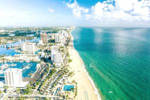 an aerial view of a beach and the ocean at Sunrise Serenade - Sun-Soaked FLL Getaway - Pool - BBQ - Near Beaches in Sunrise