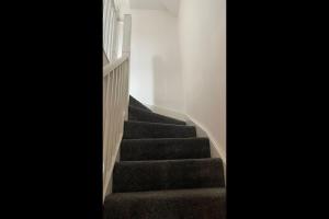 a stairway with a flight of stairs in a house at The Comfy place Shared in Dallington