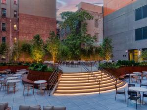 a set of stairs in a courtyard with tables and chairs at Radio Hotel in New York