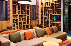 a living room with a couch and some shelves at Radio Hotel in New York