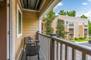 a balcony with a table and chairs and a building at 1062 Riverfront in Nashville