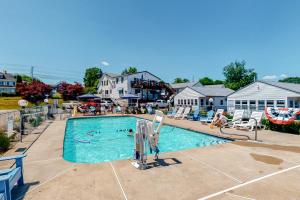 a large swimming pool with people in it at Coastal Calm Studio Cottages in Wells