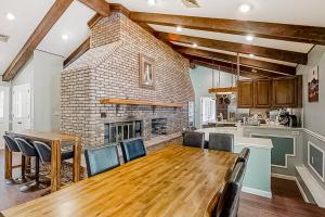 a kitchen and dining room with a table and a fireplace at Smoky Mountain Estate in Sevierville