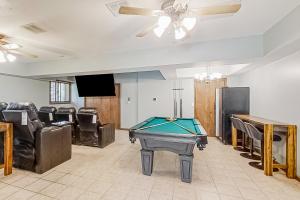a living room with a pool table and chairs at Smoky Mountain Estate in Sevierville