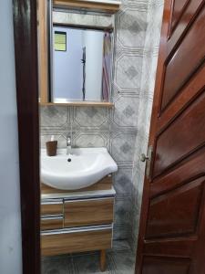 a bathroom with a sink and a mirror at Pequena Pousada in Garanhuns