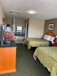 a hotel room with two beds and a television at Angus Inn Motel in Angus