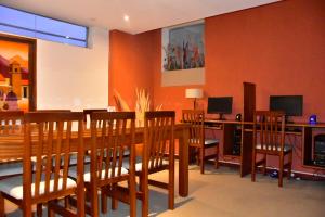 a dining room with a wooden table and chairs at Hotel Astur in Salta