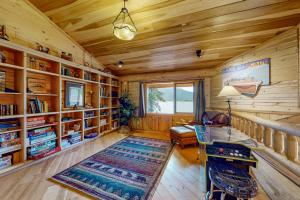 a living room with wooden walls and a wooden floor at Lakeside Lodge in Donnelly