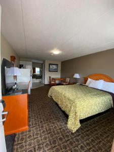 a hotel room with a bed and a kitchen at Angus Inn Motel in Angus