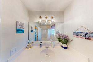 a bathroom with a sink and a mirror at Sea-Ya on Joe's Pass in Indian Pass +22 photos