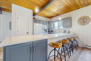a kitchen with a large counter with stools in it at Summit View in Bondville