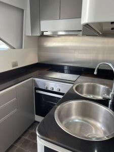 a kitchen with a stainless steel sink and a stove at Sleep Under the Stars. in Villeneuve-Loubet
