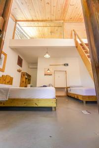 a bedroom with two beds and a loft at Casa Mar Taíba in São Gonçalo do Amarante