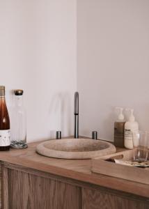 a stone sink on a wooden counter with bottles at guesthouse by good neighbor in Baltimore