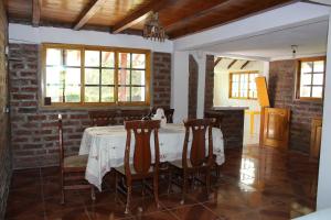 a dining room with a white table and chairs at Rumipaxi Lodge in Latacunga