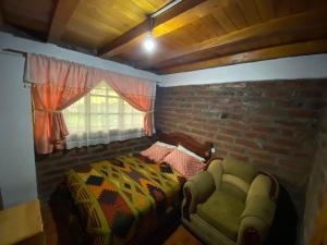 Postel nebo postele na pokoji v ubytování Rumipaxi Lodge