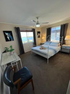 a bedroom with a bed and a chair at Fisher River Front in Griffin