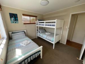 a bedroom with two bunk beds and a window at Fisher River Front in Griffin