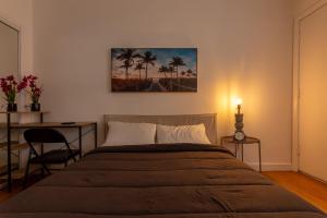a bedroom with a bed with a painting on the wall at Fort Lauderdale Studio - 5 minutes Las Olas Beach in Fort Lauderdale