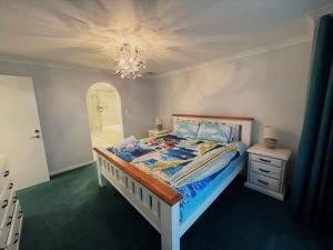 a bedroom with a bed and a chandelier at West Beach House in Esperance