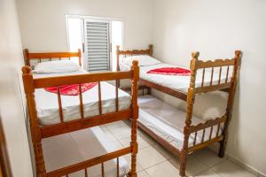 Ce dortoir comprend 2 lits superposés et une fenêtre. dans l'établissement Apartamento Praia Grande Ubatuba 2 vagas garagem Internet WiFi, à Ubatuba