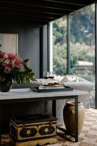 a living room with a table with wine glasses on it at Moss Manor in Moss Vale